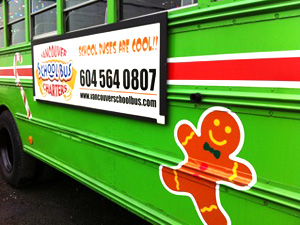 A happy gingerbread man on the side of the Cool Christmas Bus