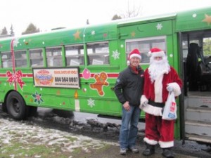 Jeff Leung and Santa in front of a Vancouver Christmas Bus